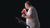 side-shooting-of-man-eating-fast-food-and-exercising-on-treadmill_vyegmlfff__F0000.png
